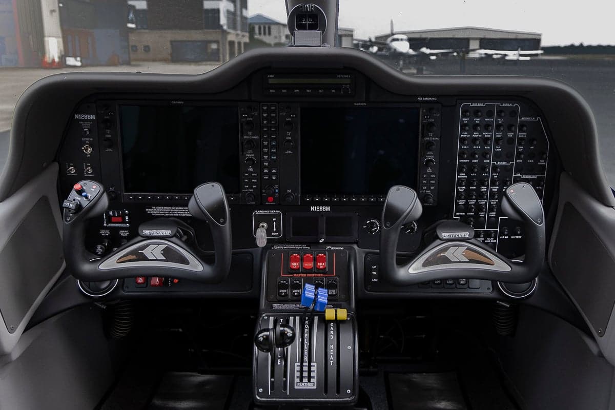 The cockpit of the Tecnam P2006T features a modern glass panel and dual control sticks.