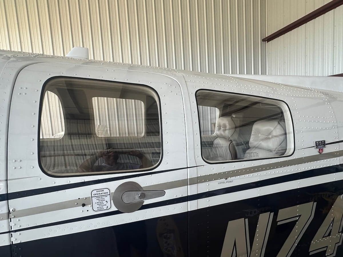 Close-up of the side of a Piper PA-31-350 Navajo Chieftain, showing the cabin windows and registration number.