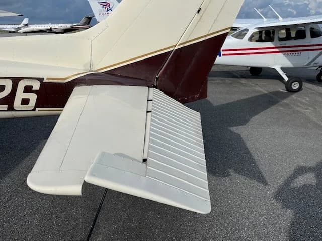 Close-up of the tail and right wing of the N75926 aircraft on an asphalt tarmac.