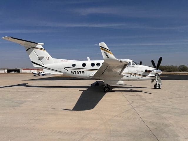The King Air 350, tail number N79TE, is parked on the tarmac.