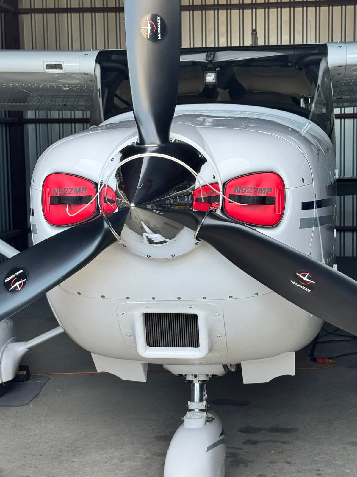 Close up of the front of the aircraft, showing the propeller and cowling.