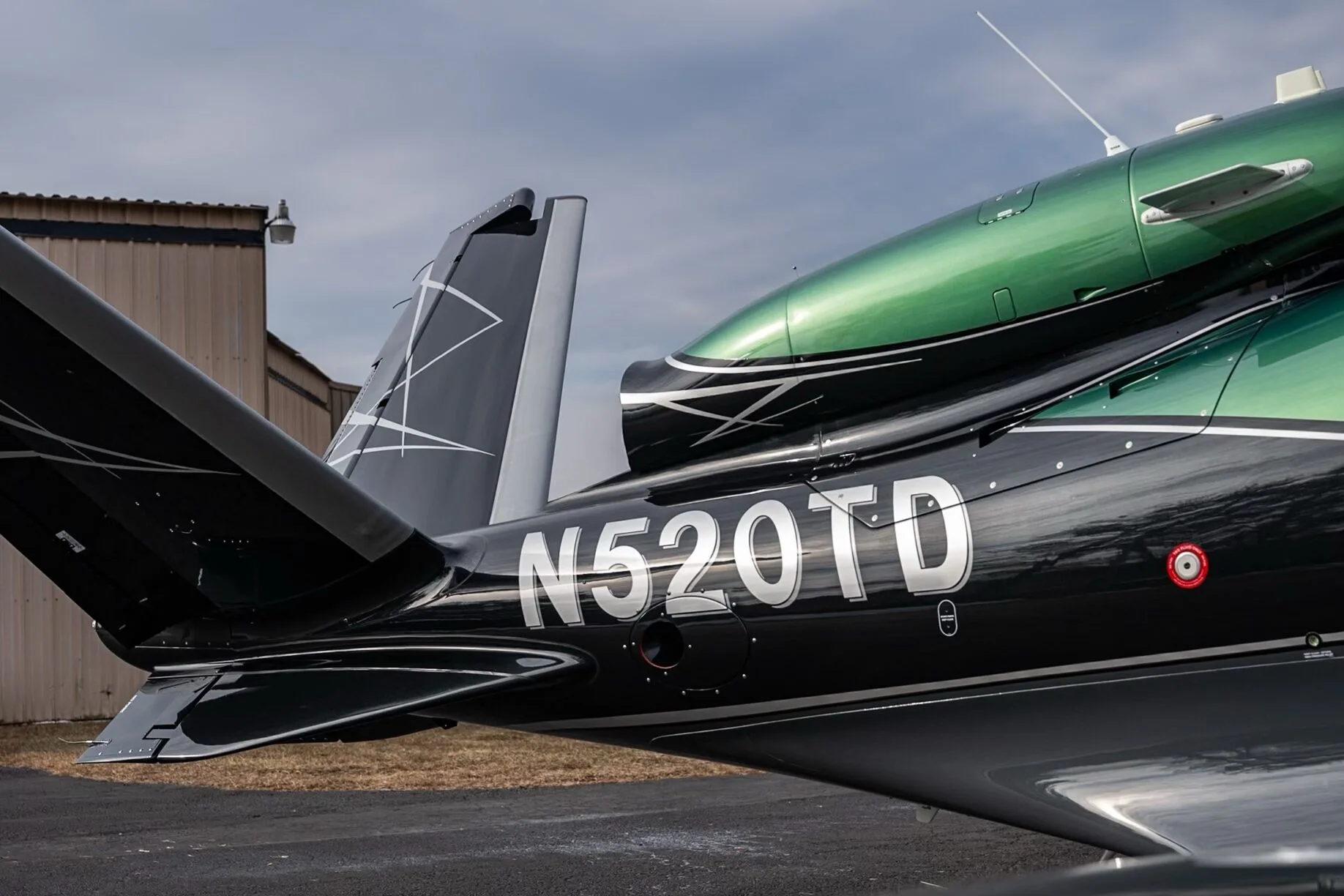 A close-up of the rear fuselage and V-tail of the Cirrus Vision Jet N520TD.