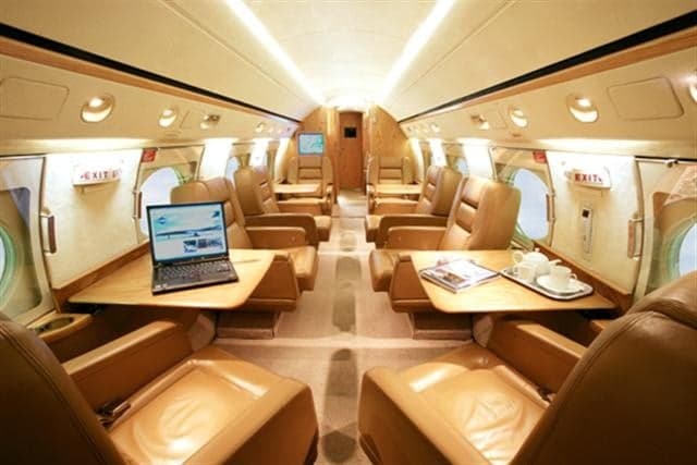 Interior view of the Gulfstream cabin with leather seats and tables.
