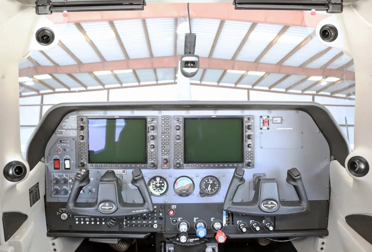 The cockpit of a Cessna Stationair TC aircraft, showing the instrument panel with two large digital displays and traditional gauges.