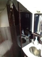 View of the aircraft's interior with a sink and mirror.