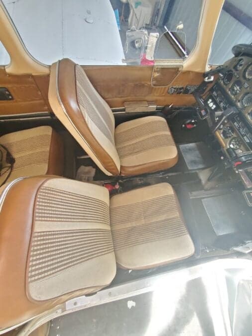 View of the aircraft's interior, showing the seats and cockpit area.