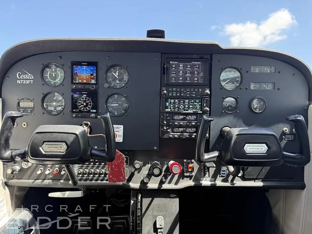 The cockpit of Cessna N733FT, featuring a mix of analog gauges and modern digital displays.