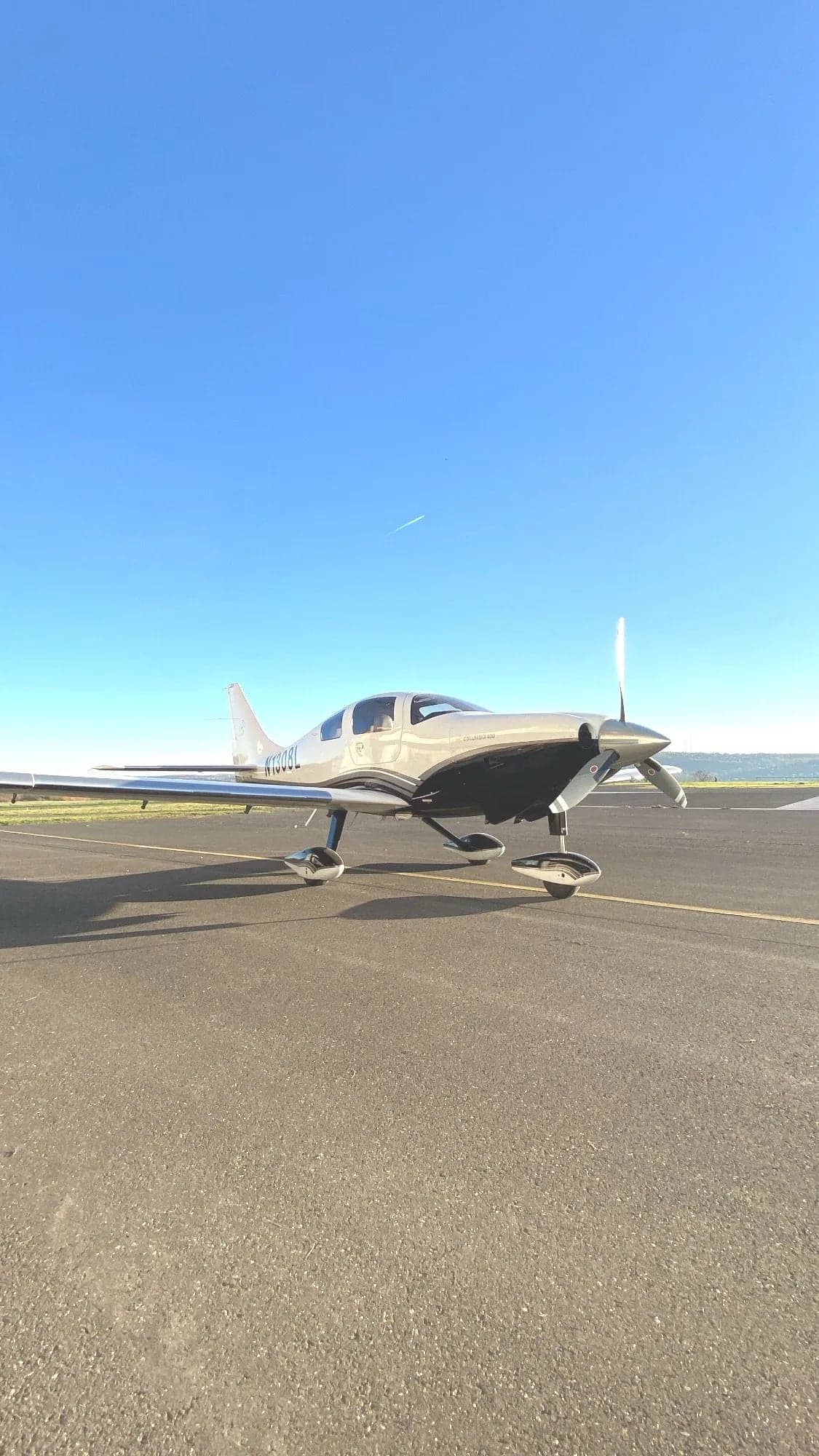 A view of the Cirrus Columbia 400's interior through the open door, showing the registration N1038L.