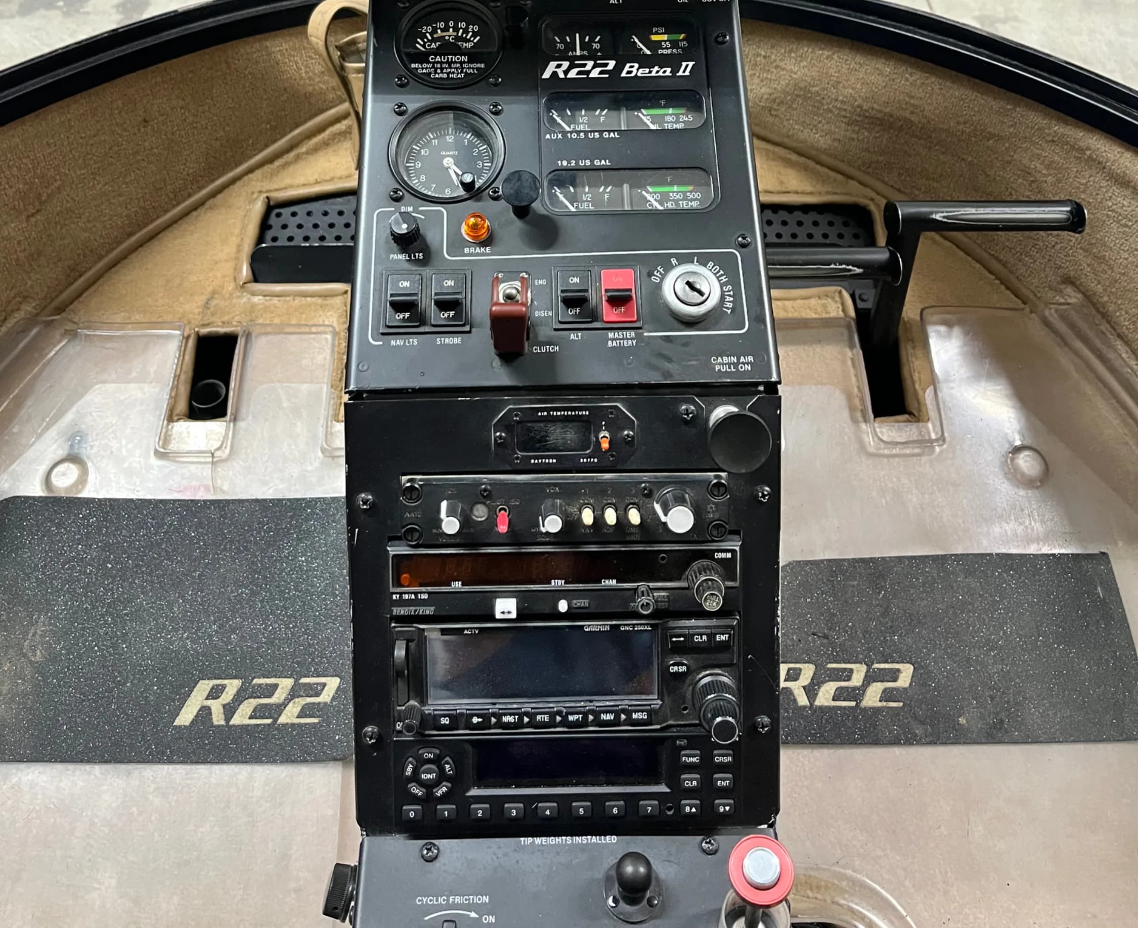 The instrument panel of a Robinson R22 Beta II helicopter, showing gauges and radio equipment.