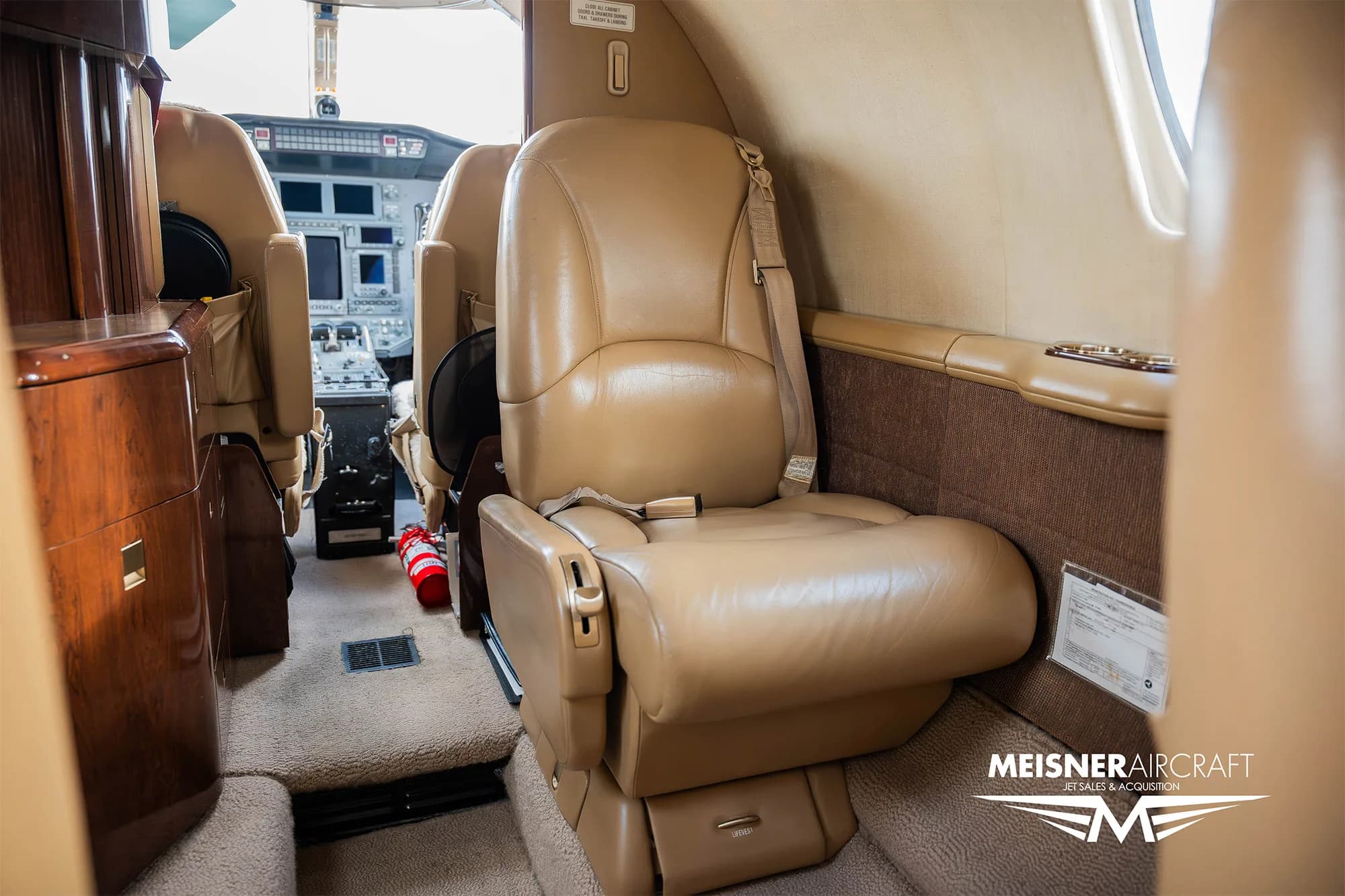 Interior view of a Cessna Citation Encore with tan leather seats.