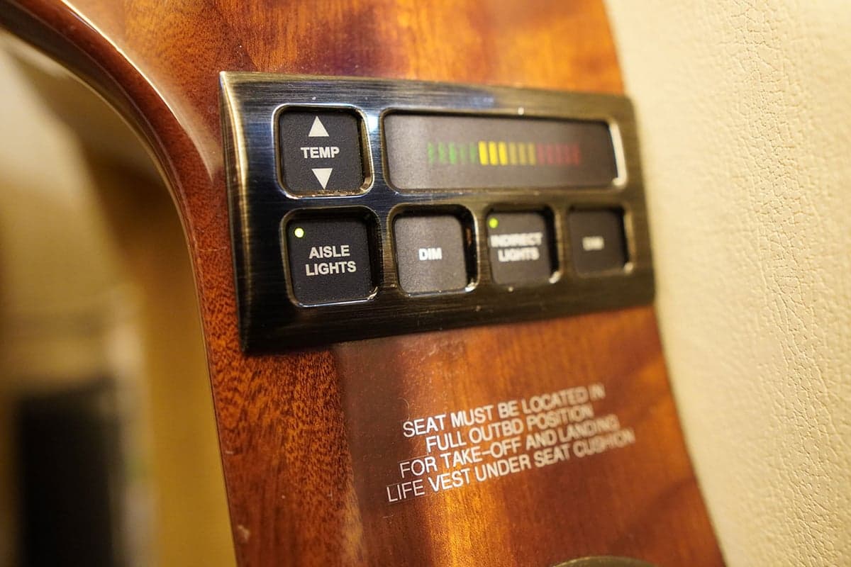 Close-up of a seat armrest in the aircraft cabin.