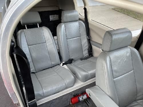 The interior of the aircraft features gray leather seats.
