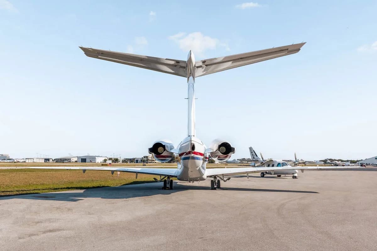 The direct rear view of a white Hawker 800XP business jet with red and blue stripes, registration N339RA, parked on the tarmac.