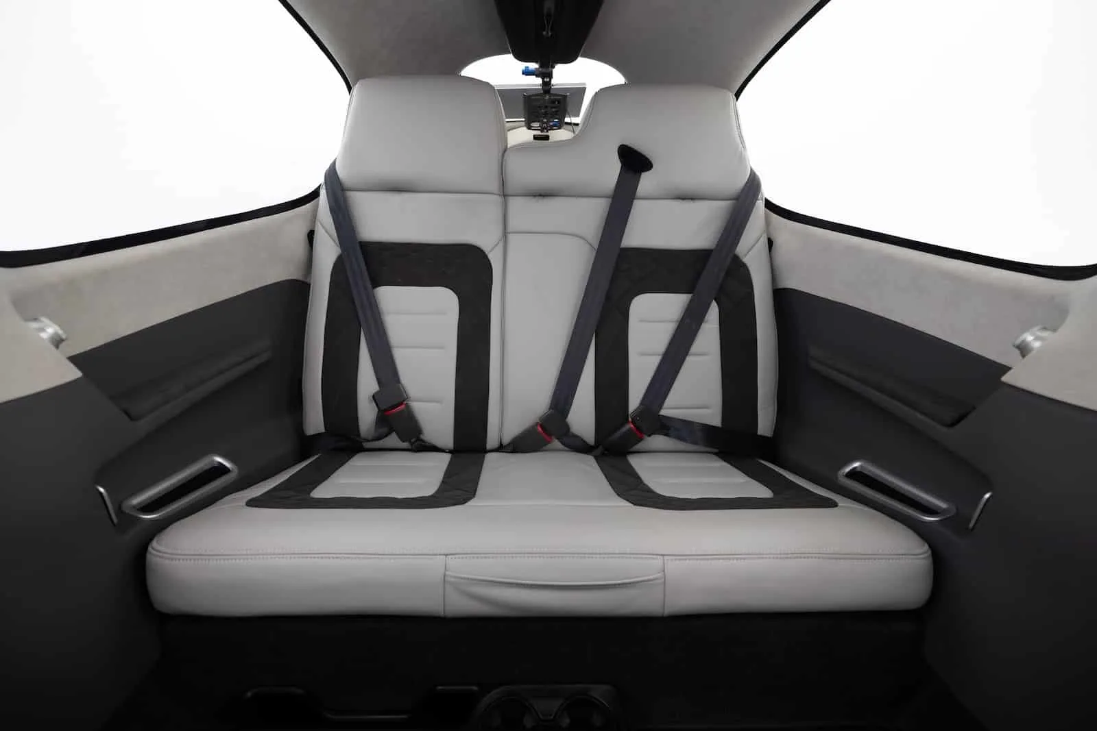 The rear seats of a Cirrus aircraft feature comfortable seating with black and gray accents.
