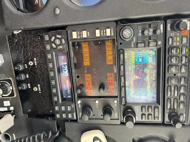 Close-up of the avionics stack in the cockpit, showing various radio and navigation units.