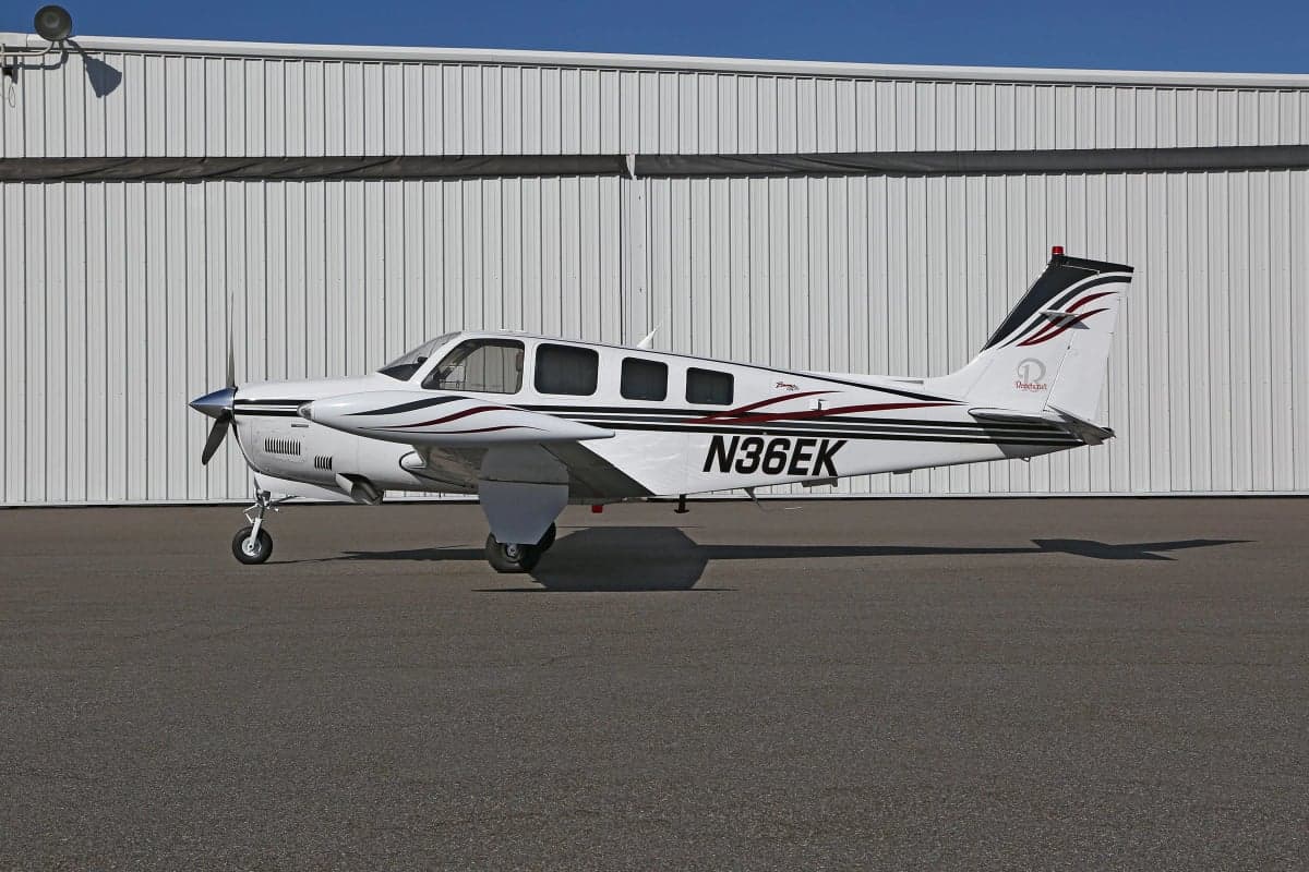 Side view of a Beechcraft Bonanza on the tarmac with registration number N36EK.