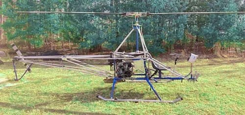 A/W-95 helicopter on a grassy field.
