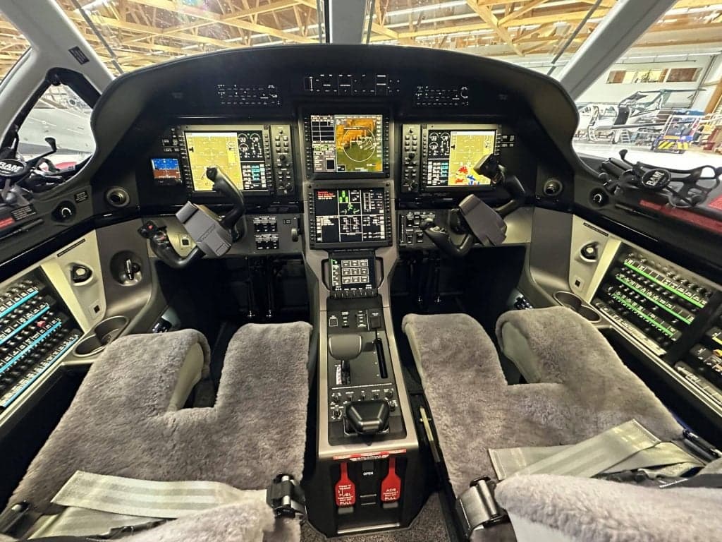 The cockpit of a Pilatus PC-12 aircraft, showing the instrument panel and controls.
