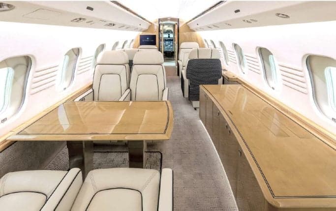 A view of the aircraft's interior with cream-colored leather seats.