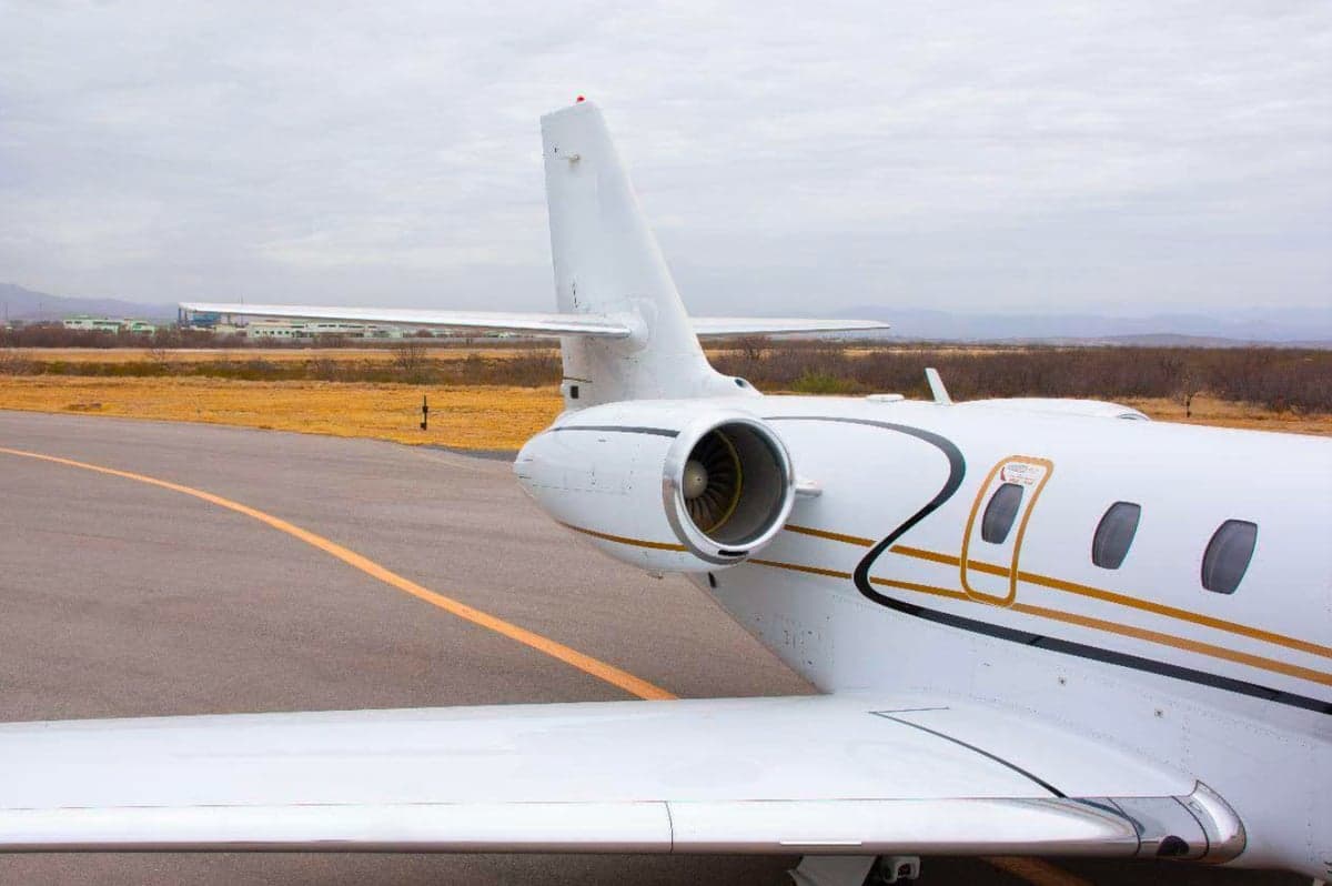 Tail section and engine of a white jet.