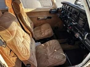 The cockpit of the aircraft features brown seats and a black instrument panel.