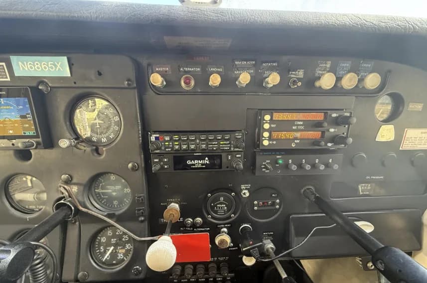 A close-up view of the right side of the Cessna 172 instrument panel, showing radios and engine controls.