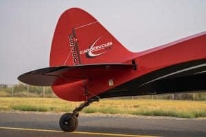 Tail section of the red and black Carbon Cub aircraft, showing the tail number.