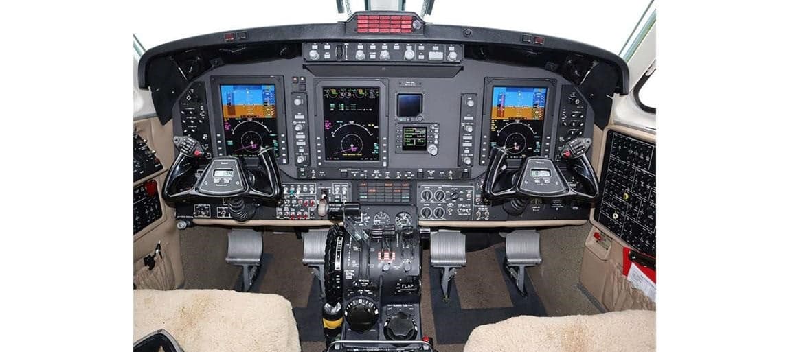 Aircraft cockpit featuring a full instrument panel and controls.