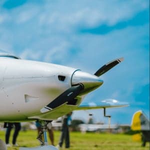 Close up of the propeller and nose of a white aircraft.