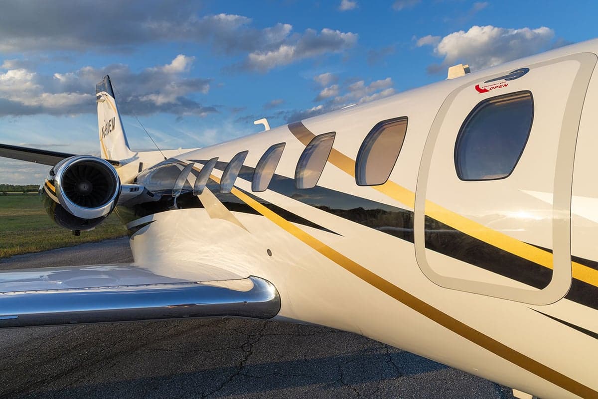 Close-up of the aircraft's fuselage, showing the windows and paint scheme.