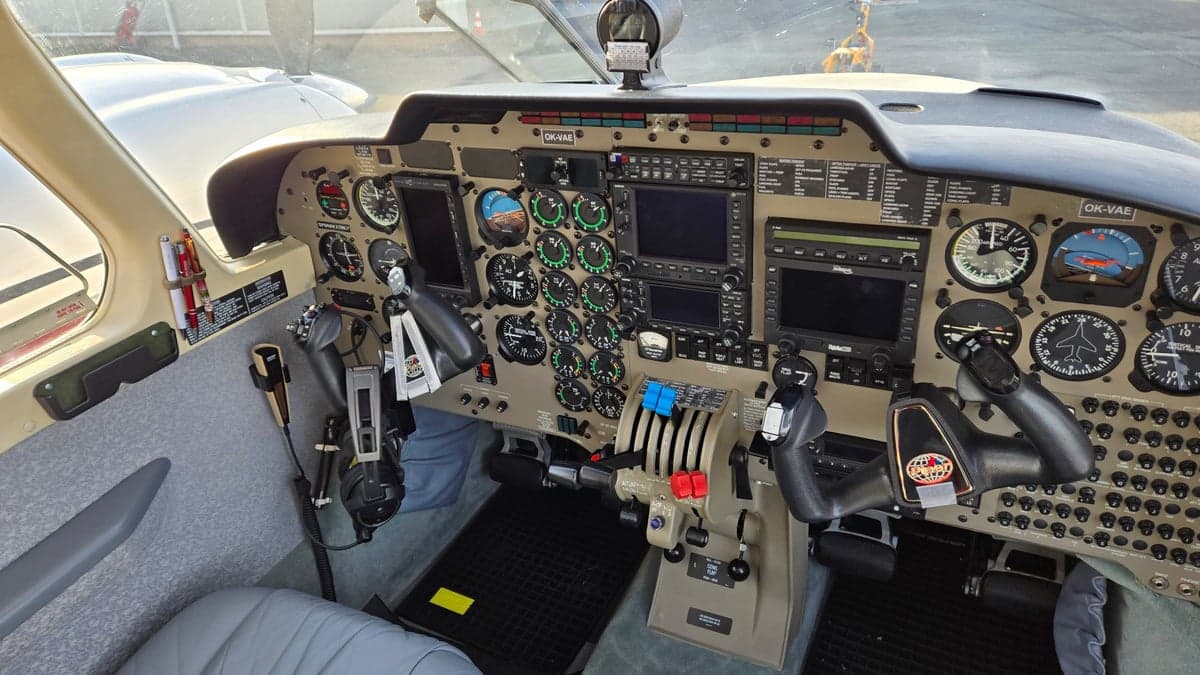 The cockpit of the aircraft shows the instrument panel and control yokes.