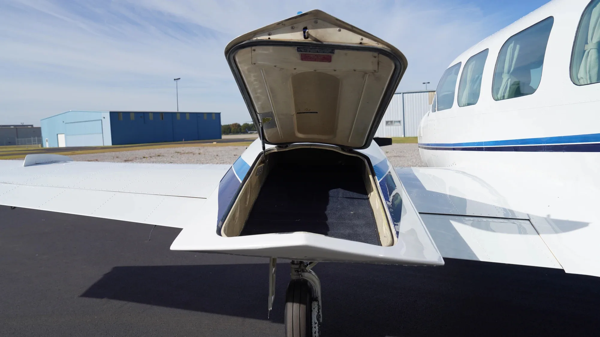 View of the aircraft's open nose baggage compartment.