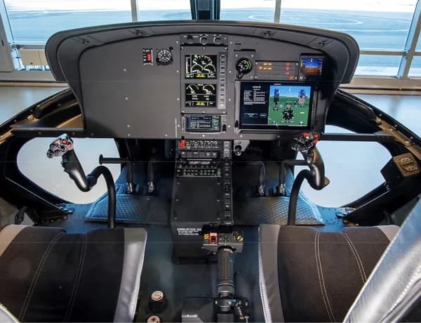 View of the helicopter cockpit instrument panel and controls.