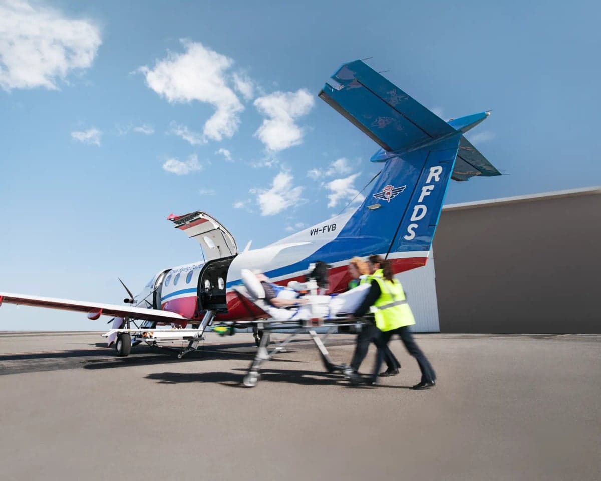 A Pilatus PC-12 aircraft with RFDS livery is used for medical transport.