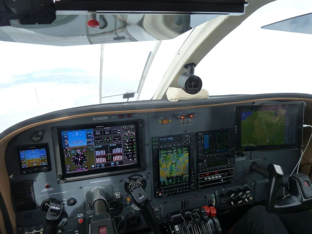 Wide view of the Cessna 414 Chancellor cockpit avionics during flight.
