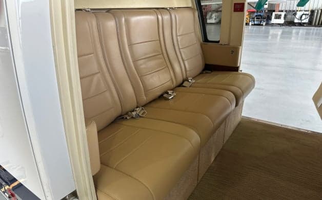 Helicopter interior with tan leather seats.