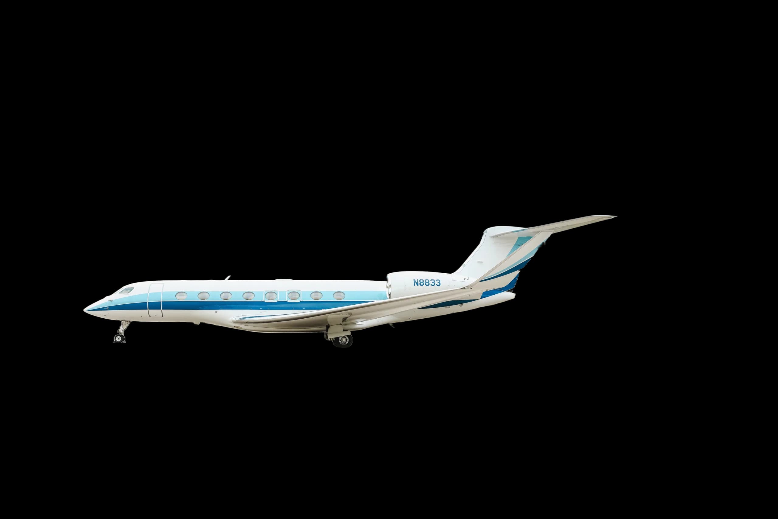 A white and blue business jet with registration N8833 is parked on the tarmac.