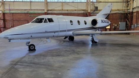 Hawker 400XP aircraft N226WH parked on the tarmac with the door open.