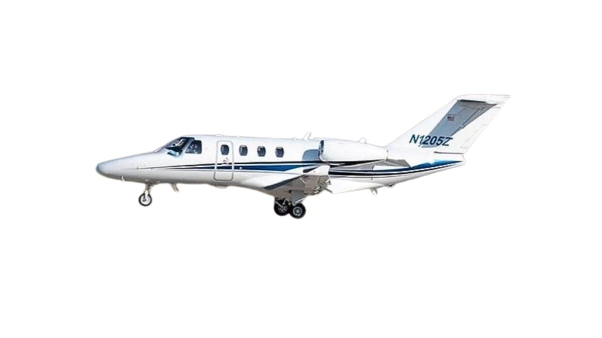 Side view of a white and blue Cessna Citation jet aircraft with registration N1205Z.