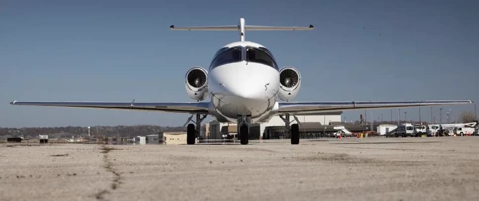 Front view of a Hawker 400XP aircraft parked on the tarmac.