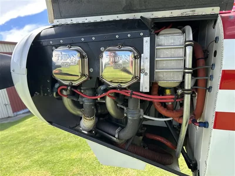 Another view of the Super Cub's open engine compartment, showing the Titan engine and cooling fins.