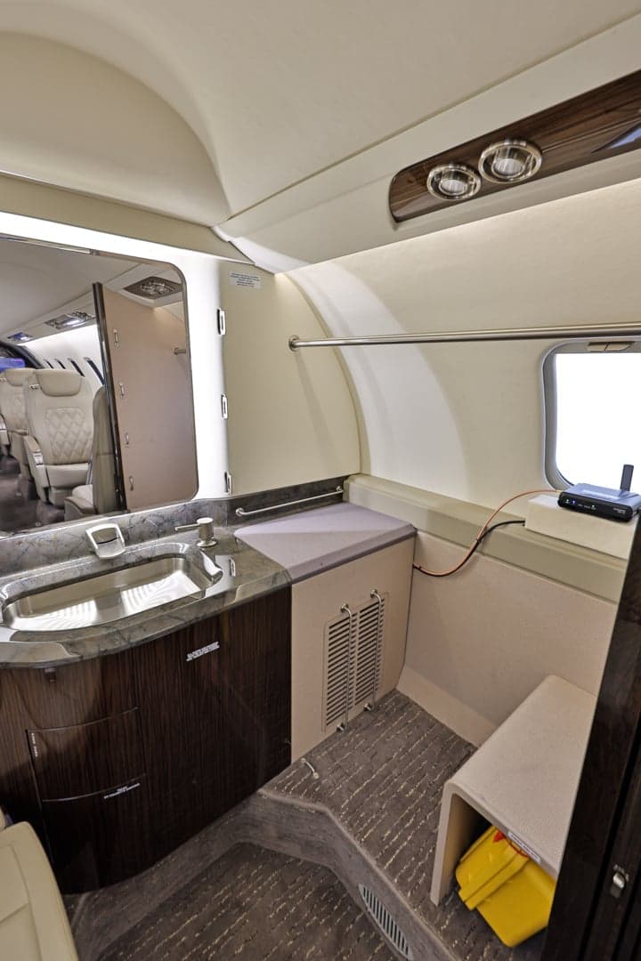 View of the Learjet 45XR lavatory with sink and storage.