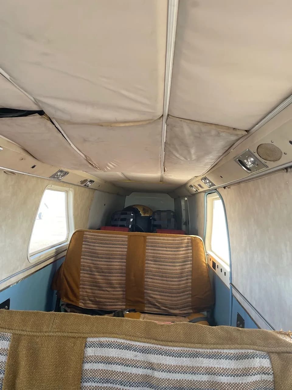 View of the aircraft's interior cabin from the back.