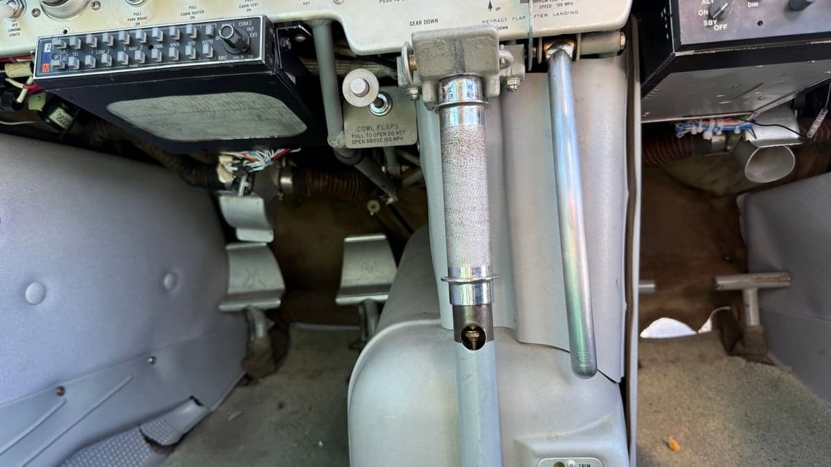 View of the rudder pedals and lower instrument panel of the aircraft.