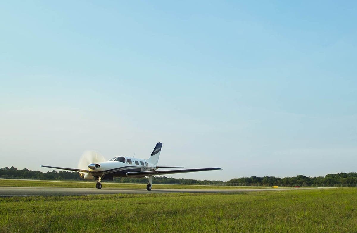 Piper M350 taxiing on a runway.