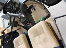 View of the helicopter cockpit with instrument panel and seats.