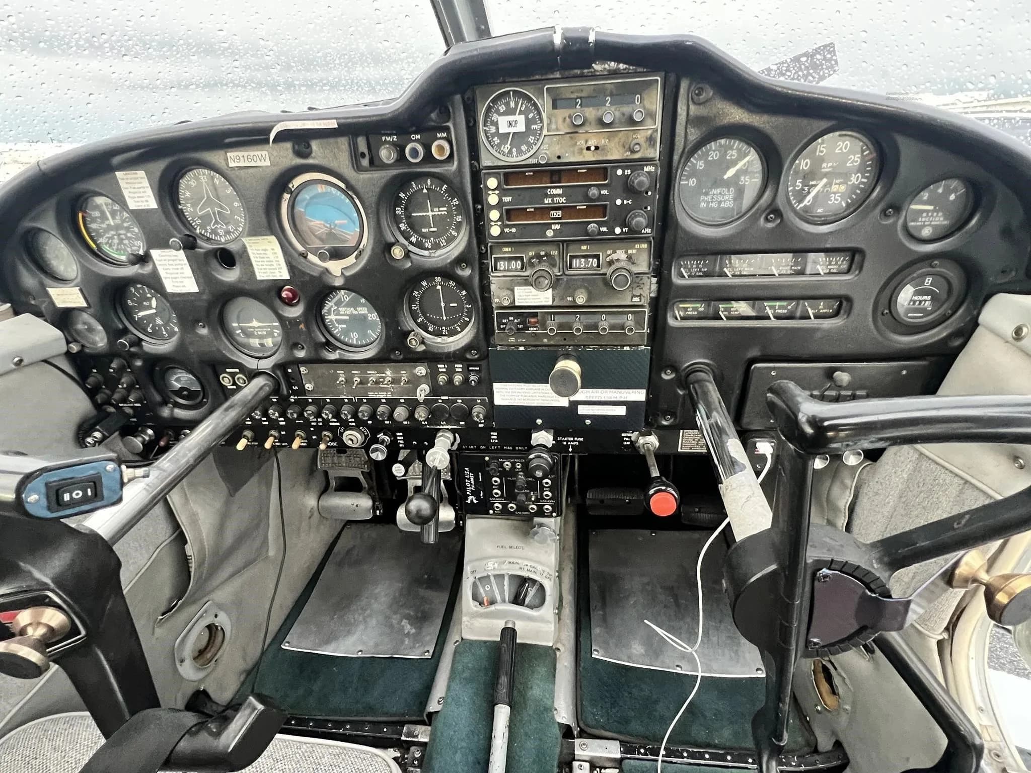 Detailed view of the instrument panel, radios, and controls in the Piper Cherokee 235 B cockpit.