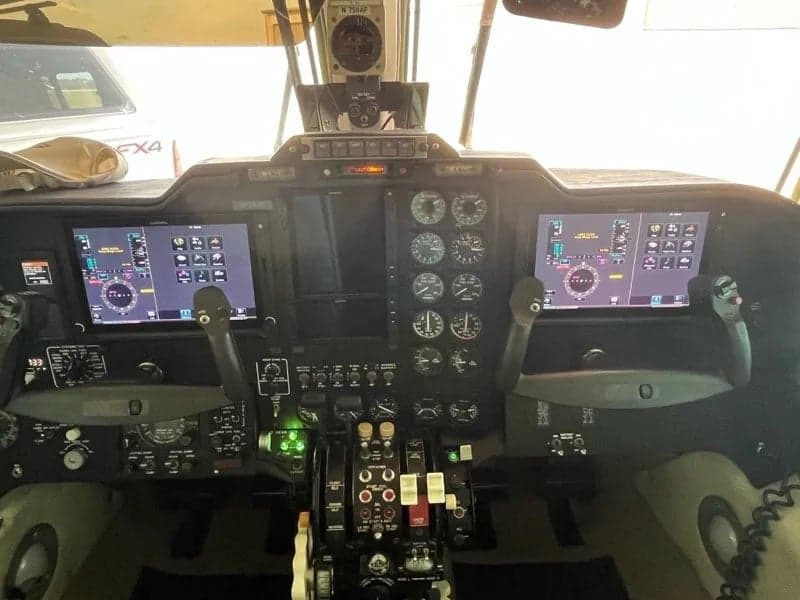 The cockpit of the aircraft features a modern glass panel display.