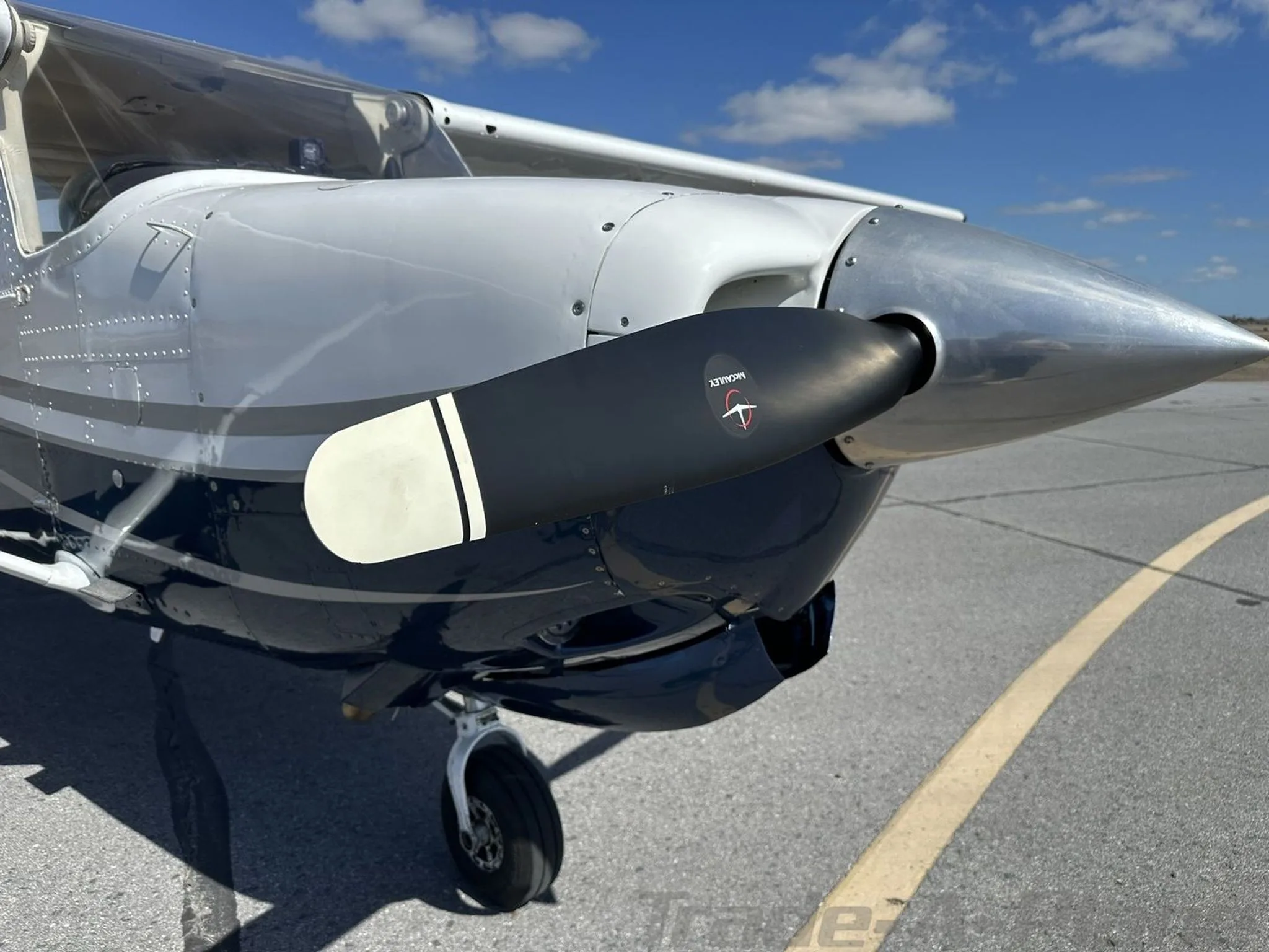 Close-up view of the propeller and engine cowling of the N108EA aircraft.