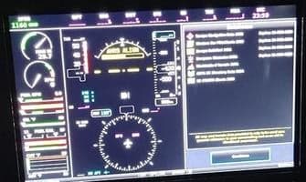 A close-up view of a modern aircraft's digital cockpit display showing flight instruments and navigation information.